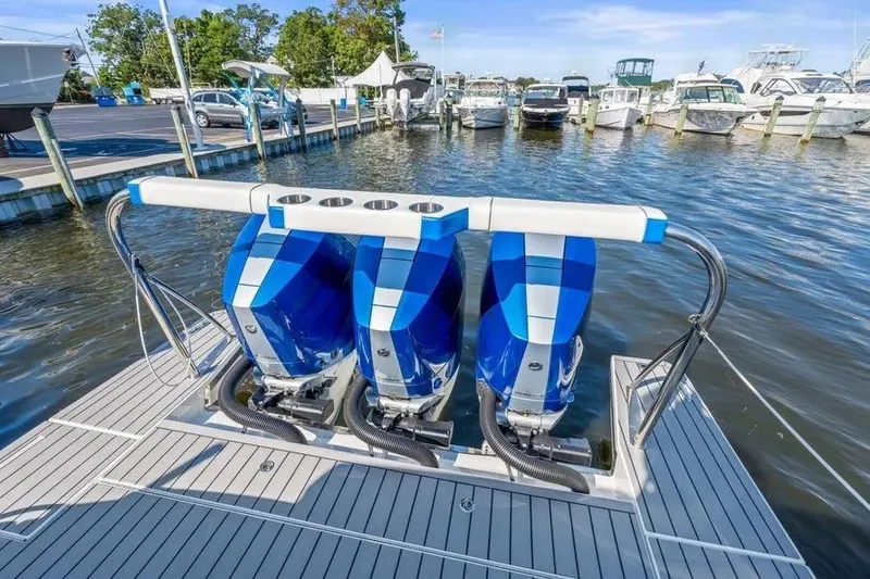 Slide: The Image of 2024 Formula 380 Super Sport Crossover OB with triple outboard engines at marina. - 12