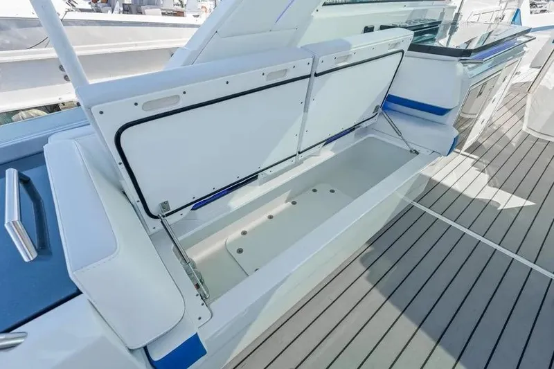 Slide: The Image of 2024 Formula 380 Super Sport Crossover OB boat storage compartment open on deck. - 13