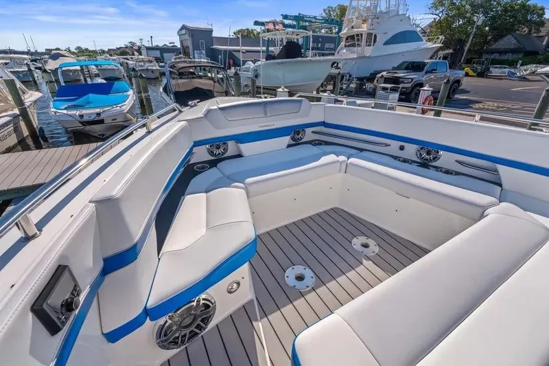 Slide: The Image of 2024 Formula 380 Super Sport Crossover OB boat interior with spacious seating at marina. - 15