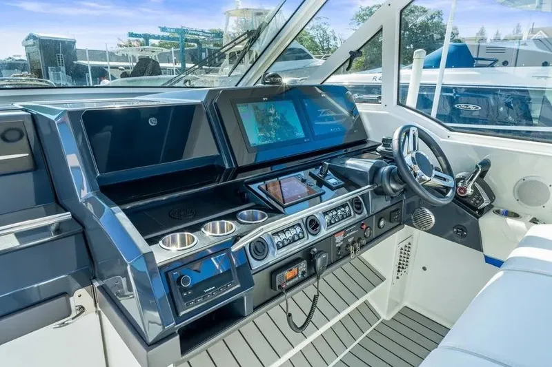 Slide: The Image of 2024 Formula 380 Super Sport Crossover OB helm with advanced navigation systems and controls. - 16