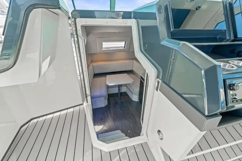 Slide: The Image of 2024 Formula 380 Super Sport Crossover OB cabin interior with modern seating and table. - 22