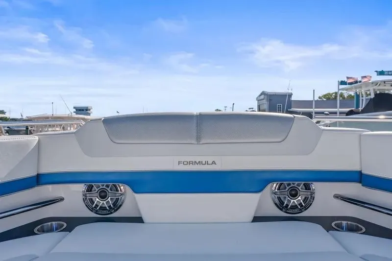 Slide: The Image of 2024 Formula 380 Super Sport Crossover OB boat interior with speakers and seating. - 24