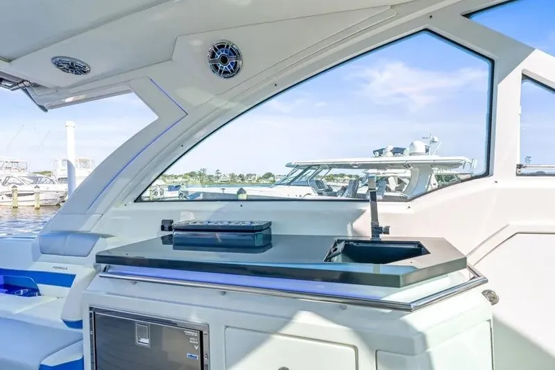 Slide: The Image of 2024 Formula 380 Super Sport Crossover OB interior with sleek kitchenette and marina view. - 25