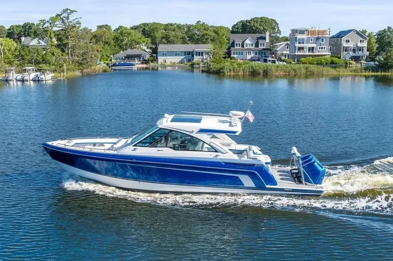 Slide: The Image of 2024 Formula 380 Super Sport Crossover OB cruising on a scenic lake. - 3