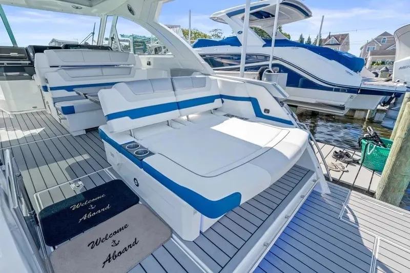 Slide: The Image of 2024 Formula 380 Super Sport Crossover OB luxury boat interior with seating and welcome mats. - 35