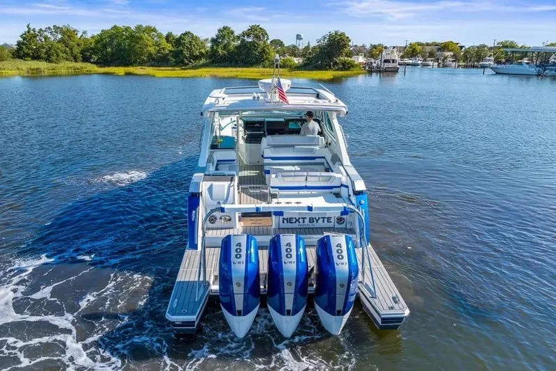 Slide: The Image of 2024 Formula 380 Super Sport Crossover OB cruising on a serene lake. - 52