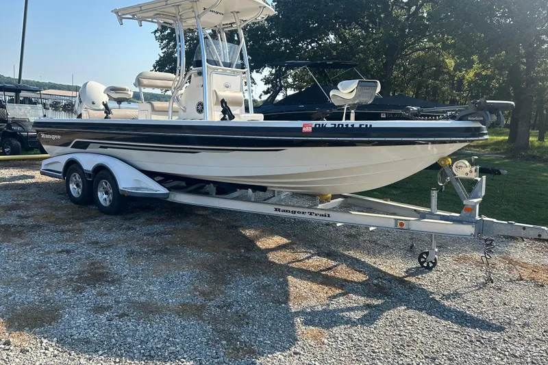 The Image of 2009 Ranger 2410 Bay Ranger boat on trailer, parked outdoors on gravel. - 0