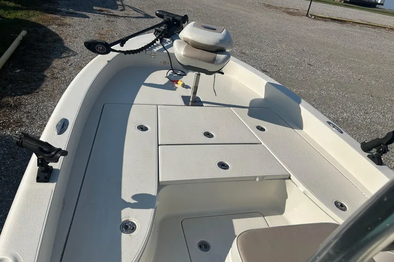 Slide: The Image of 2009 Ranger 2410 Bay Ranger boat interior with seating and storage compartments. - 12