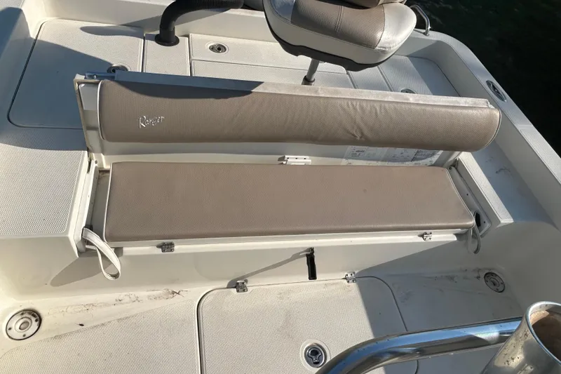 Slide: The Image of 2009 Ranger 2410 Bay Ranger boat seating area with beige cushions. - 19