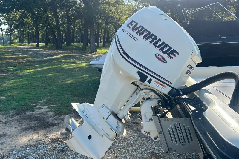 Slide: The Image of 2009 Ranger 2410 Bay Ranger with Evinrude E-TEC outboard motor in a wooded area. - 5