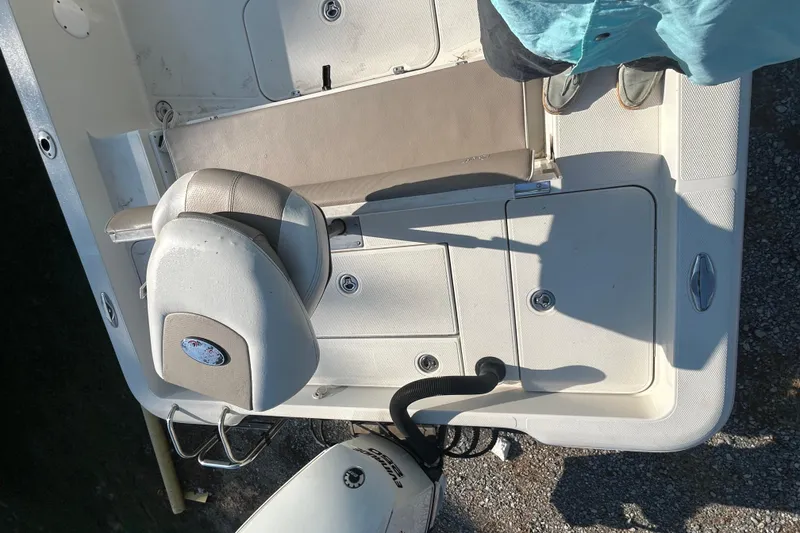 Slide: The Image of 2009 Ranger 2410 Bay Ranger boat interior with seating and storage compartments. - 7