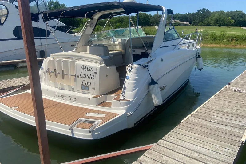 Slide: The Image of 2003 Rinker 342 Express Cruiser on calm water under cloudy skies. - 1