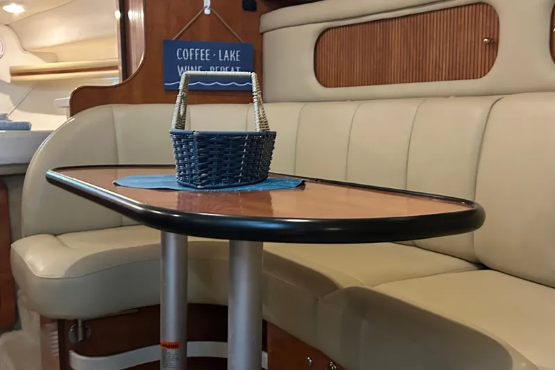 Slide: The Image of Interior of 2003 Rinker 342 Express Cruiser with beige seating and wooden table. - 20