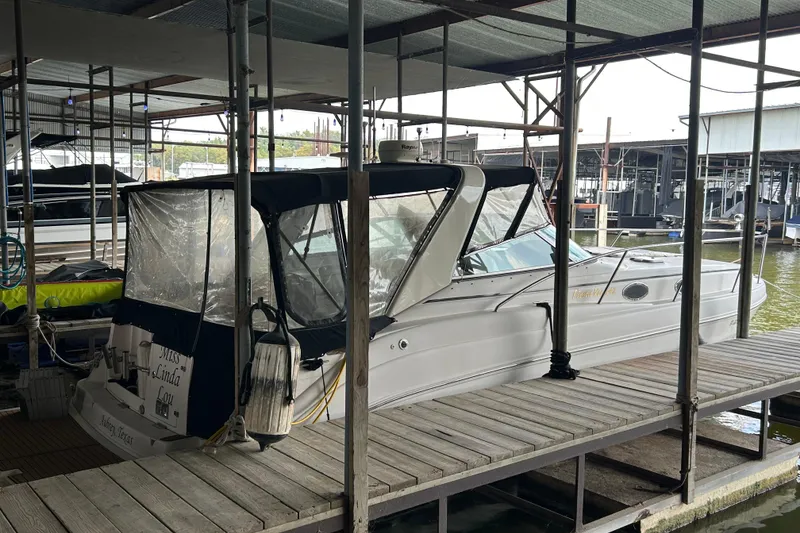 Slide: The Image of 2003 Rinker 342 Express Cruiser docked in a covered marina. - 29
