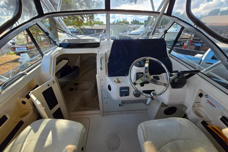 Slide: The Image of 2008 Grady-White Gulfstream 232 boat interior with steering wheel and seating. - 13