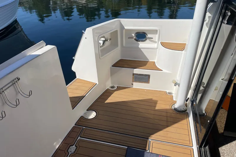 Slide: The Image of 1997 McKinna 48 Pilothouse boat deck with teak flooring and stainless steel fixtures. - 10