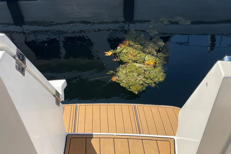 Slide: The Image of Stern view of 1997 McKinna 48 Pilothouse with floating debris in water. - 11