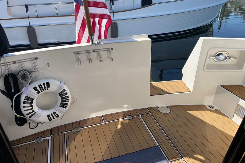 Slide: The Image of 1997 McKinna 48 Pilothouse deck with life preserver and American flag. - 13