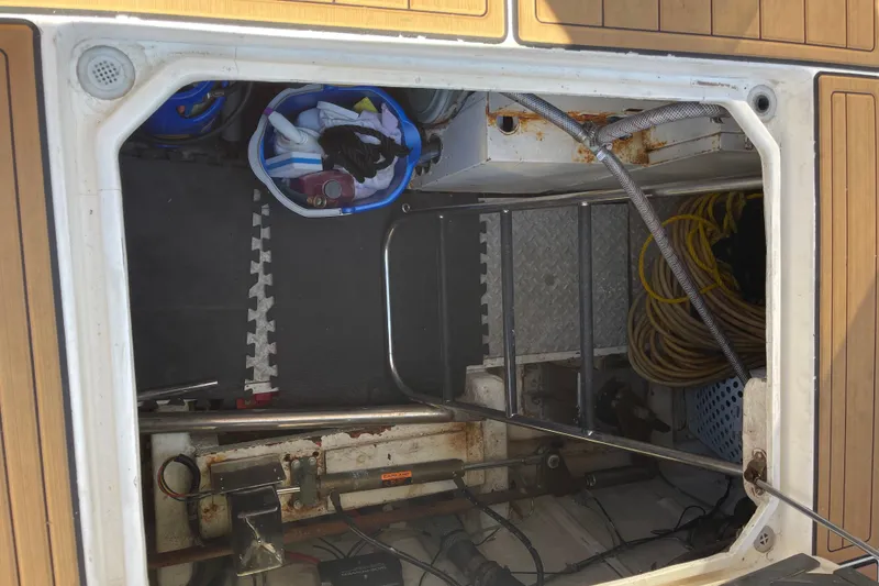 Slide: The Image of Open storage compartment on 1997 McKinna 48 Pilothouse with tools and equipment. - 14