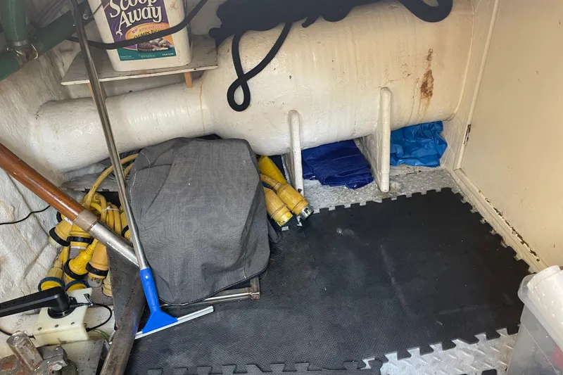 Slide: The Image of Storage area in a 1997 McKinna 48 Pilothouse with tools and supplies. - 15