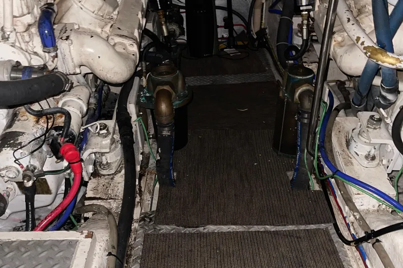 Slide: The Image of Engine room of a 1997 McKinna 48 Pilothouse with visible machinery and wiring. - 24