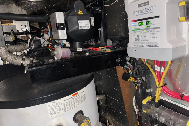 Slide: The Image of Engine room of 1997 McKinna 48 Pilothouse with electrical components and wiring. - 26