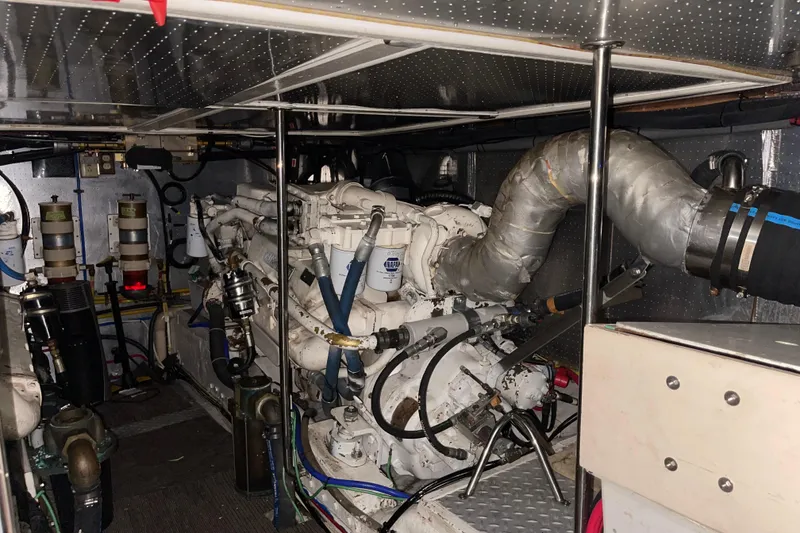 Slide: The Image of Engine room of a 1997 McKinna 48 Pilothouse yacht, showcasing mechanical components. - 27