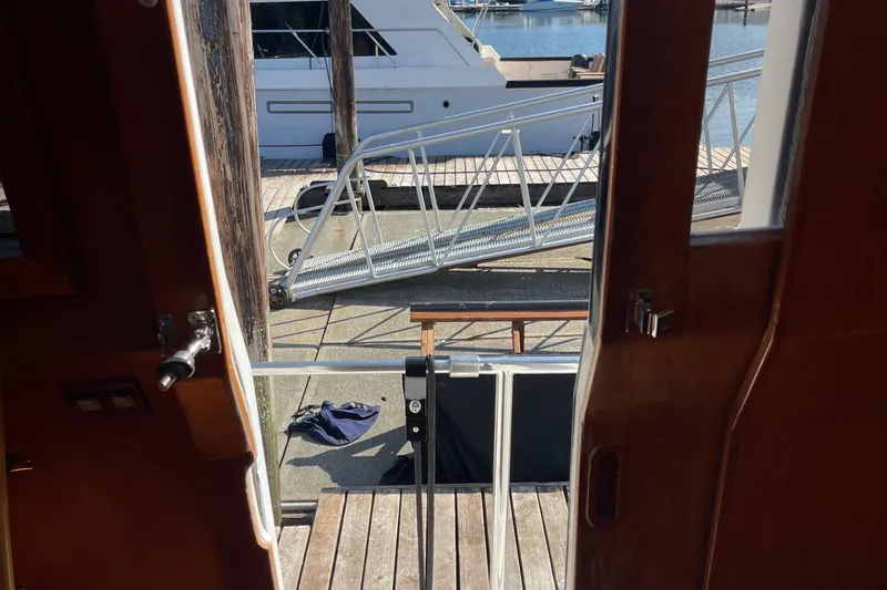 Slide: The Image of View from 1997 McKinna 48 Pilothouse, showing dock and nearby boat. - 28