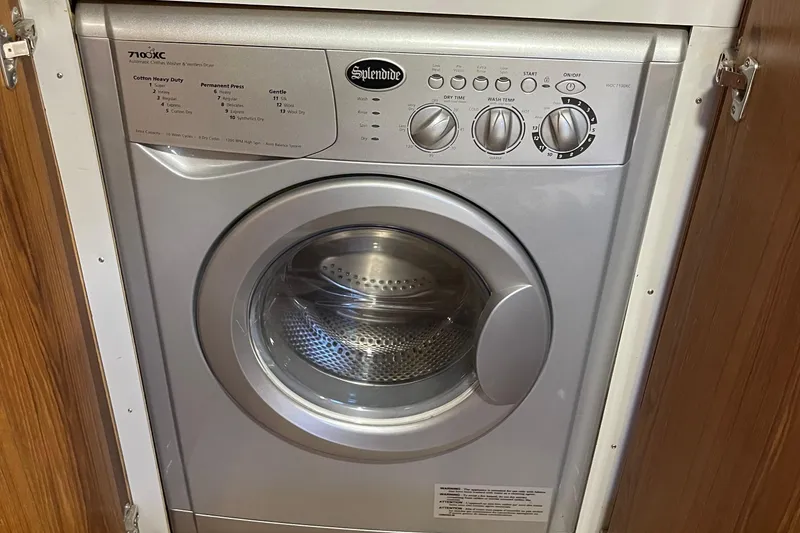 Slide: The Image of Splendide washer-dryer unit in a 1997 McKinna 48 Pilothouse yacht interior. - 30