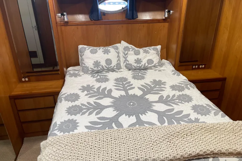 Slide: The Image of Cozy bedroom in 1997 McKinna 48 Pilothouse with floral bedding and wooden accents. - 31