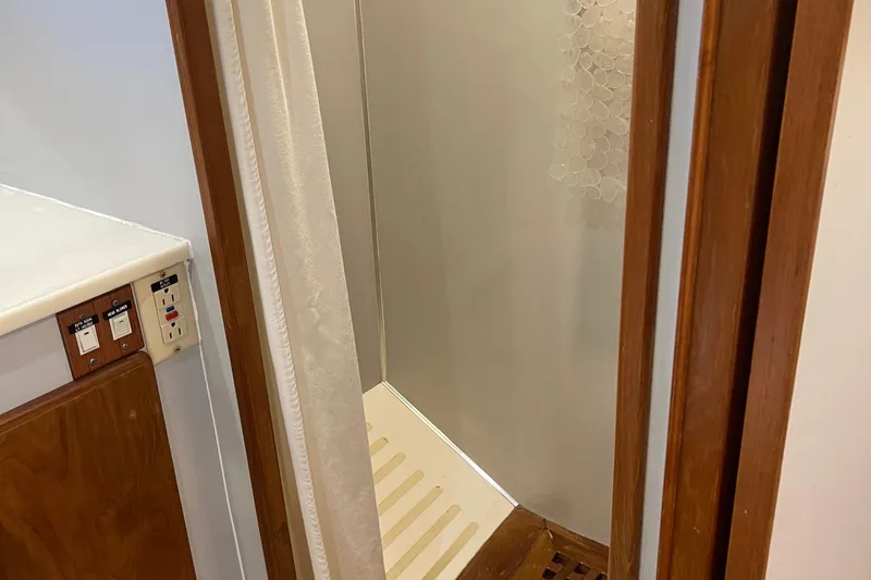 Slide: The Image of Shower area in 1997 McKinna 48 Pilothouse with wooden trim and control panel. - 33