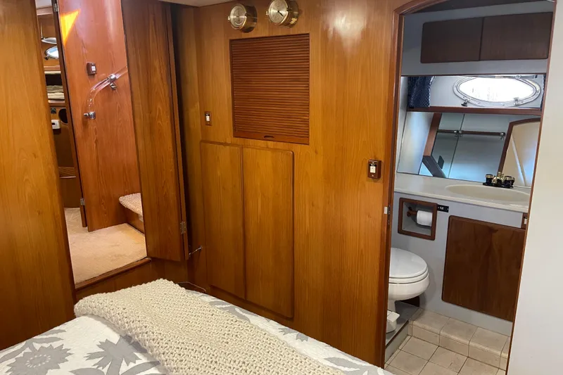 Slide: The Image of Interior of 1997 McKinna 48 Pilothouse yacht with wood paneling and bathroom. - 34