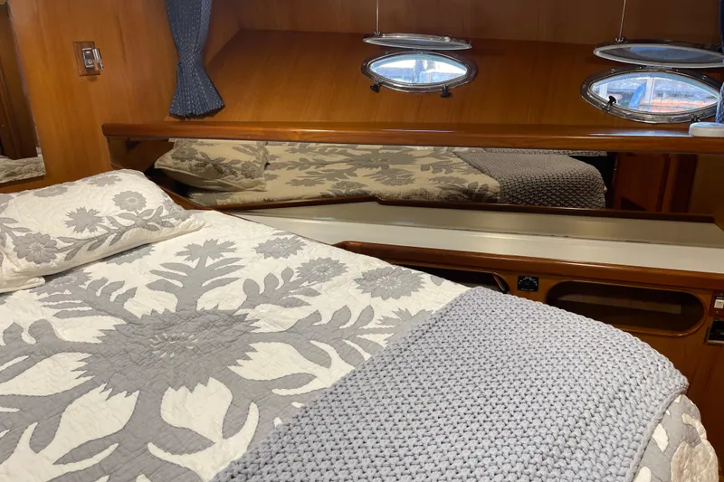 Slide: The Image of Cozy bedroom in 1997 McKinna 48 Pilothouse with floral bedding and porthole windows. - 36