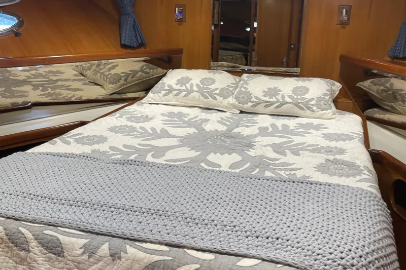 Slide: The Image of Luxurious cabin interior of 1997 McKinna 48 Pilothouse with elegant bedding and wood paneling. - 37