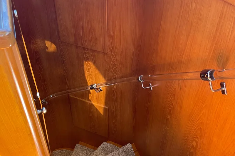 Slide: The Image of Staircase with wooden paneling and clear handrail on 1997 McKinna 48 Pilothouse yacht. - 39