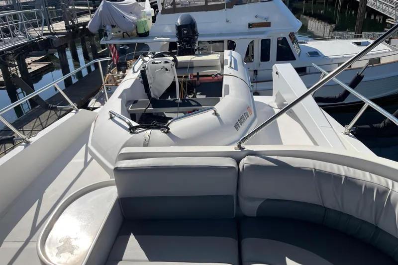 Slide: The Image of 1997 McKinna 48 Pilothouse yacht with inflatable boat on deck, docked at marina. - 44