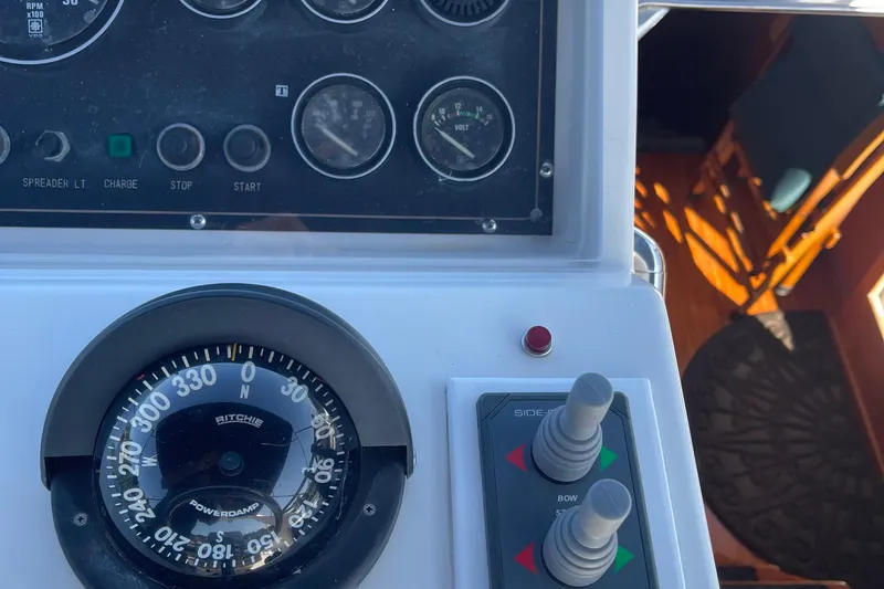 Slide: The Image of Control panel of a 1997 McKinna 48 Pilothouse with compass and gauges. - 46