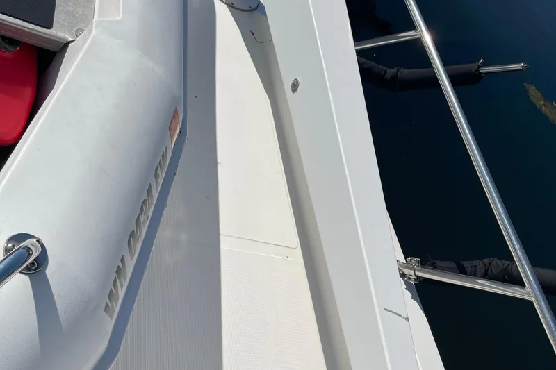 Slide: The Image of 1997 McKinna 48 Pilothouse yacht deck with railing and inflatable boat. - 50