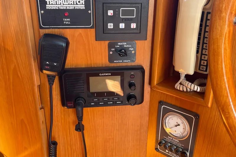 Slide: The Image of Control panel of a 1997 McKinna 48 Pilothouse with communication and monitoring systems. - 53