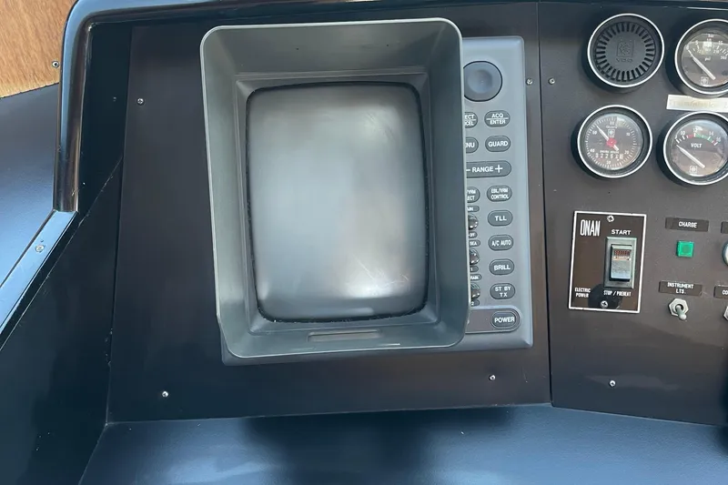 Slide: The Image of Control panel of a 1997 McKinna 48 Pilothouse with gauges and switches. - 58