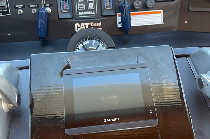 Slide: The Image of 1997 McKinna 48 Pilothouse helm with Garmin display and CAT Diesel controls. - 60