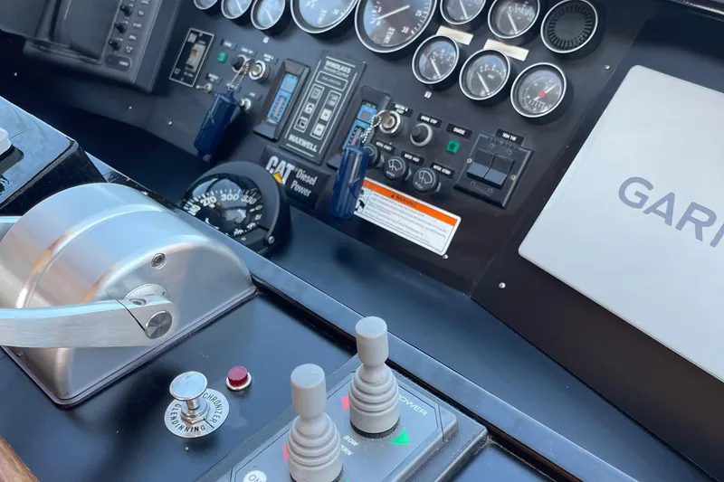 Slide: The Image of Control panel of a 1997 McKinna 48 Pilothouse with gauges and navigation equipment. - 62