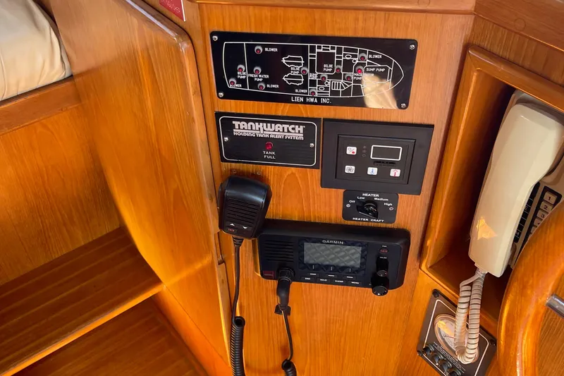 Slide: The Image of Control panel of a 1997 McKinna 48 Pilothouse with communication and monitoring systems. - 63