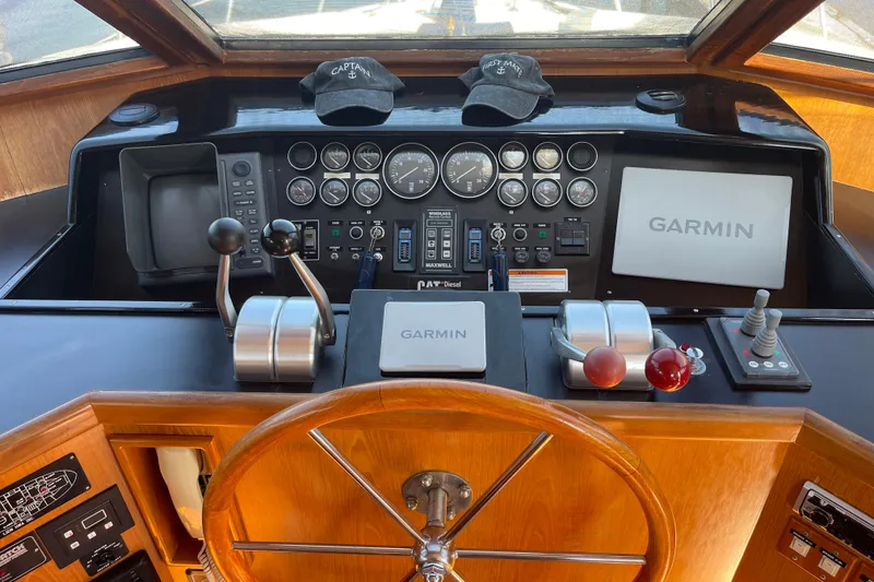 Slide: The Image of 1997 McKinna 48 Pilothouse helm with Garmin navigation and control instruments. - 64
