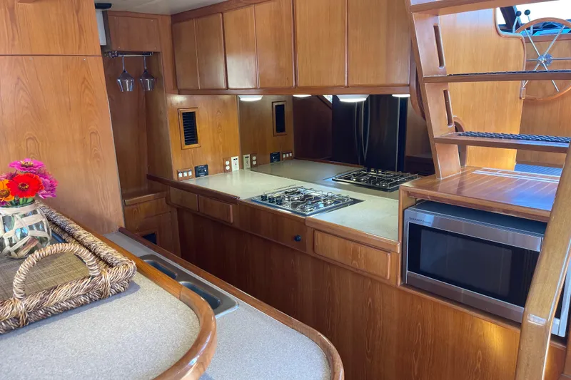 Slide: The Image of Wooden interior of 1997 McKinna 48 Pilothouse yacht kitchen with stove and microwave. - 68