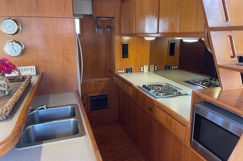 Slide: The Image of Luxurious 1997 McKinna 48 Pilothouse yacht kitchen with wood cabinetry and modern appliances. - 69