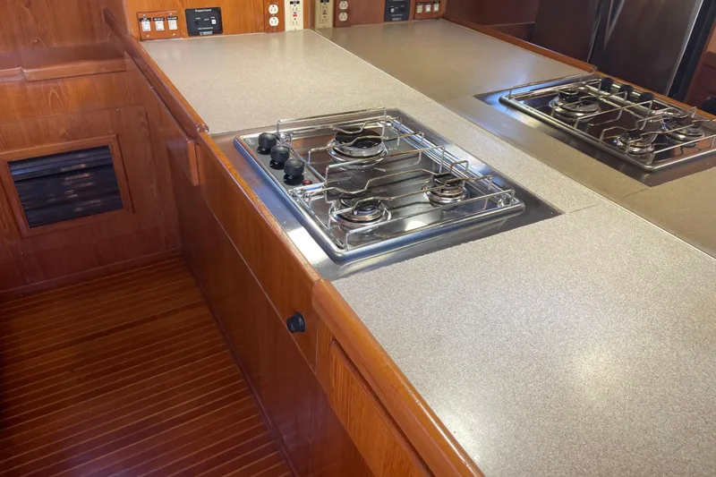 Slide: The Image of 1997 McKinna 48 Pilothouse kitchen with dual gas stoves and wooden cabinetry. - 71
