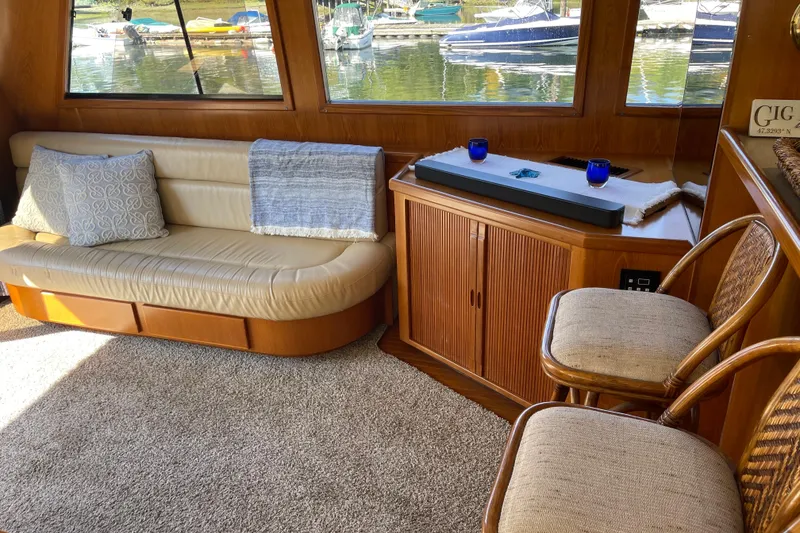 Slide: The Image of Luxurious interior of 1997 McKinna 48 Pilothouse yacht with elegant seating and waterfront view. - 77