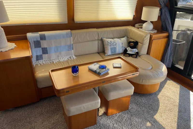 Slide: The Image of Cozy interior of 1997 McKinna 48 Pilothouse with plush seating and wooden table. - 79