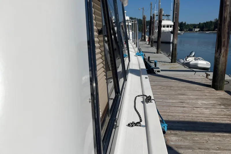 Slide: The Image of Side view of 1997 McKinna 48 Pilothouse yacht docked at marina. - 9